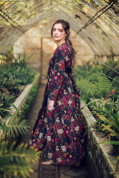 Free photo woman with floral dress and bare feet