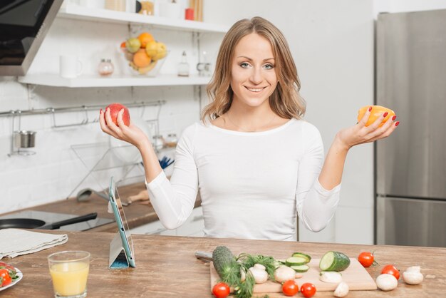 Woman with fruits in kitchen