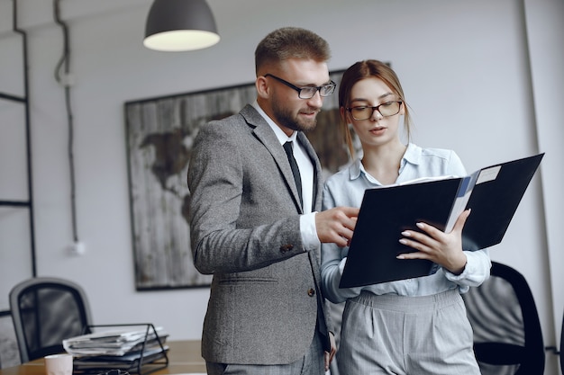 Woman with glasses.Businessman with documents.Colleagues work together