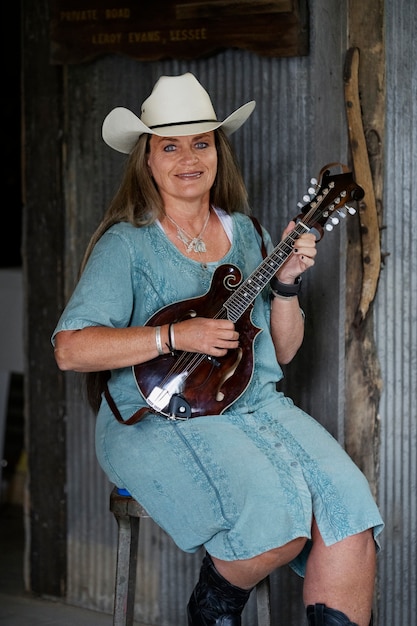 Woman with guitar getting ready for country music concert