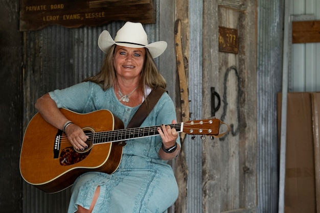 Free Photo woman with guitar getting ready for country music concert