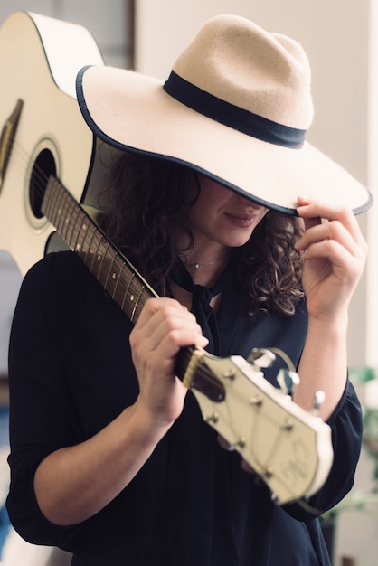 Free photo woman with guitar and hat