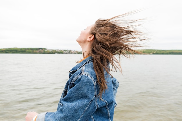 Free photo woman with hair blown by wind