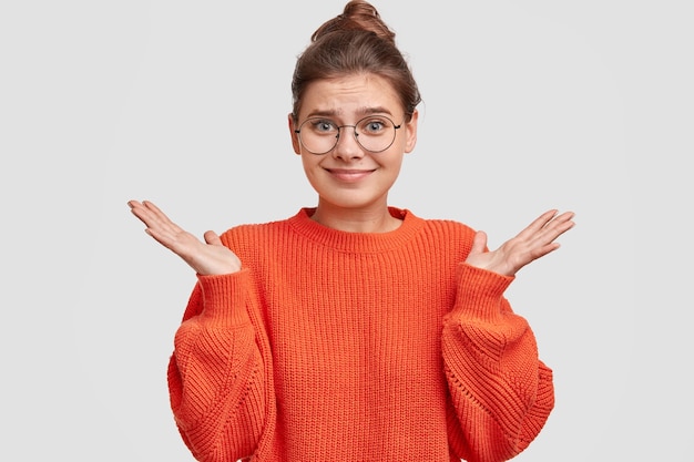 Free Photo woman with hair in a bun wearing oversized sweater