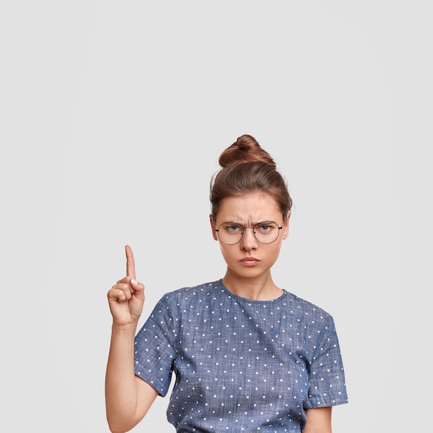 Free Photo woman with hair in a bun wearing polka dot blouse