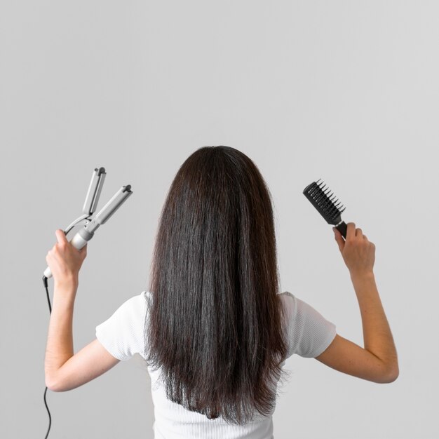 Woman with hair straightener