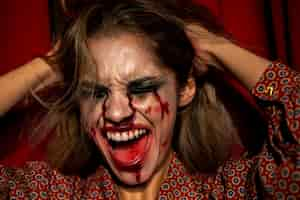 Free photo woman with halloween joker makeup screaming