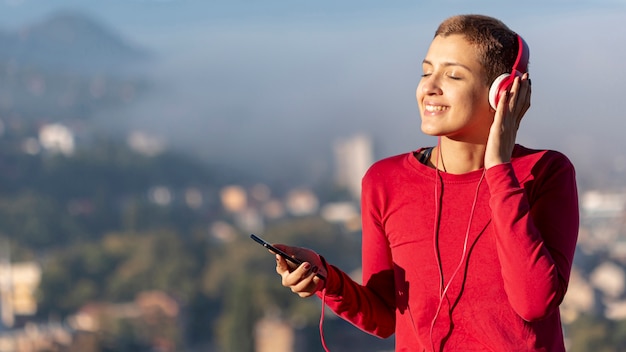 Free photo woman with headphones medium shot