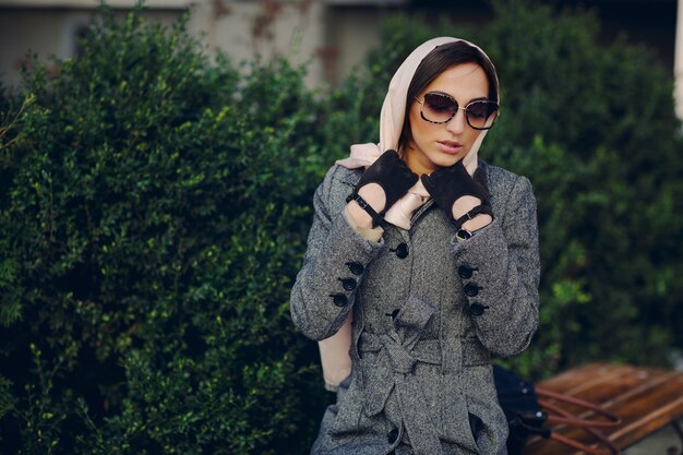 Woman with a headscarf and gloves