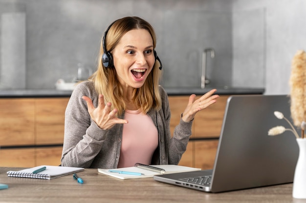 Free Photo woman with headset working on laptop