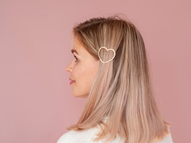 Free photo woman with heart shaped hair clip