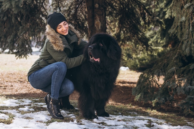 Free photo woman with her dog walking in park