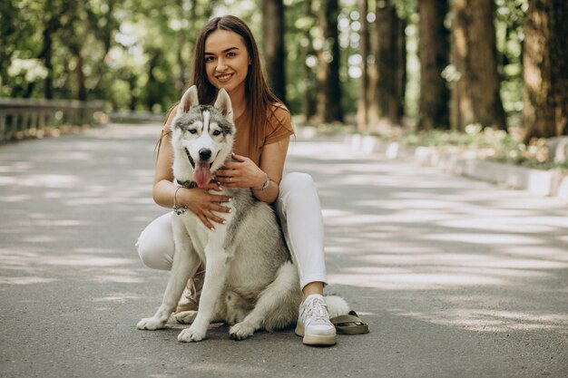 Woman with her husky dog in the park