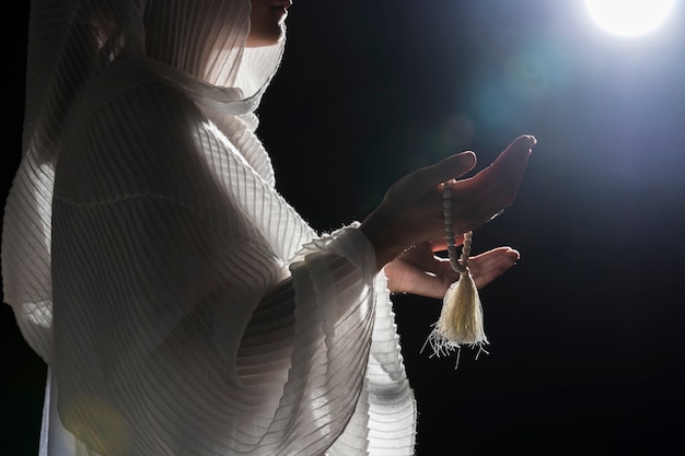 Woman with holy bracelet praying