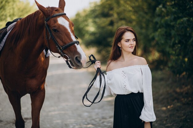 Woman with horse in forest