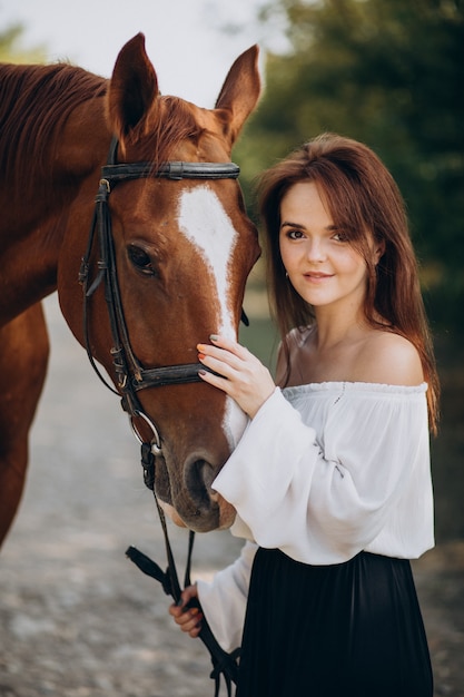 Woman with horse in forest