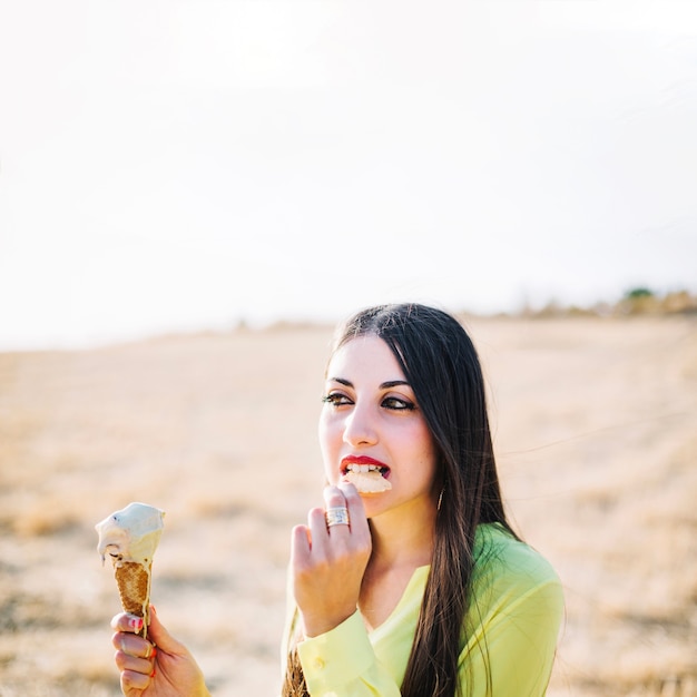 Woman with ice cream in park