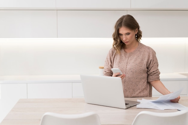 Woman with laptop and documents