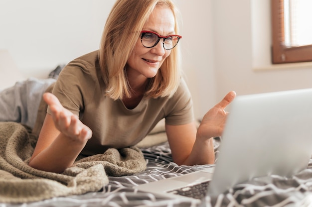 Woman with laptop in quarantine at home