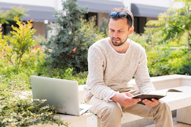 Free photo woman with laptop and tablet working outdoors