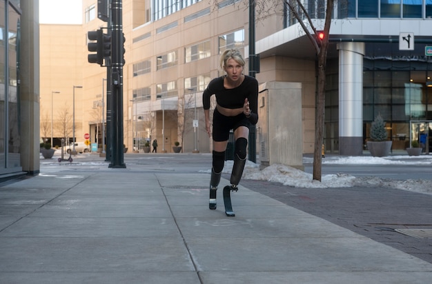 Woman with leg disability running in the city