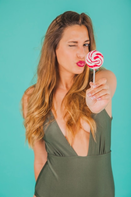 Free photo woman with lollipop making kiss mouth