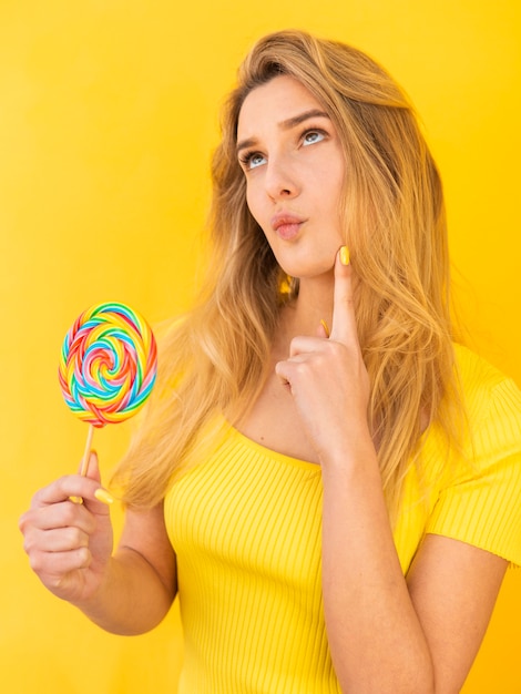 Woman with lollipop thinking