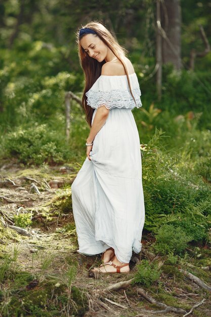 Woman with long hair. Lady in a blue dress. Girl with untouched nature.