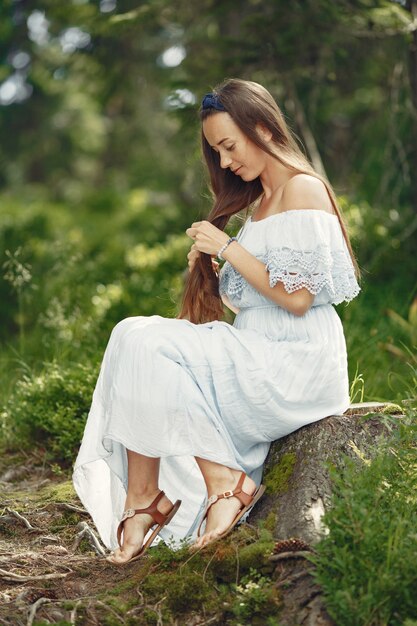 Woman with long hair. Lady in a blue dress. Girl with untouched nature.