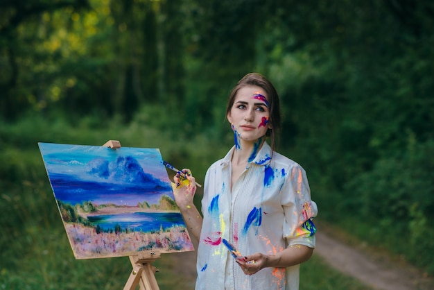 Woman with lost look holding a paintbrush