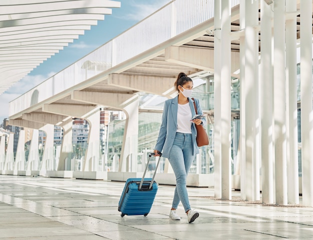 Woman with luggage during pandemic at the airport