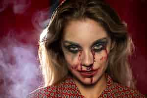 Free photo woman with make-up as blood looking at camera