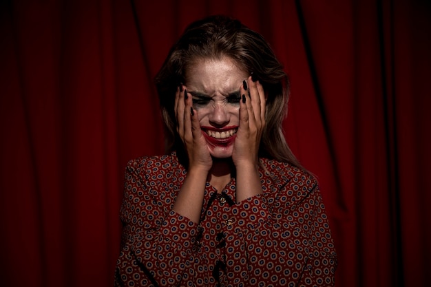 Free Photo woman with make-up blood on her face crying