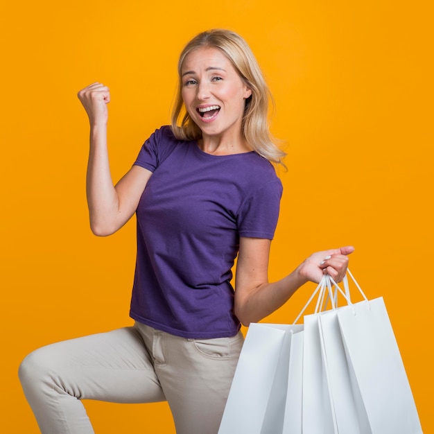 Free photo woman with many shopping bags being happy about her sale shopping spree