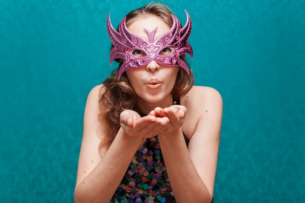 Free Photo woman with mask blowing a kiss