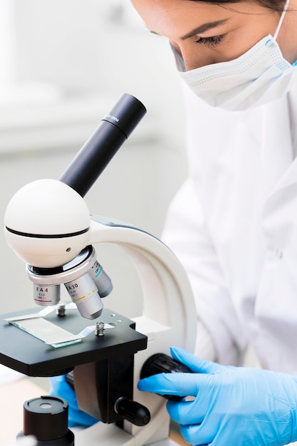 Woman with mask and microscope