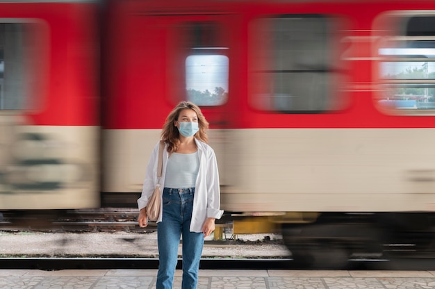 Free photo woman with medical mask at the public train station