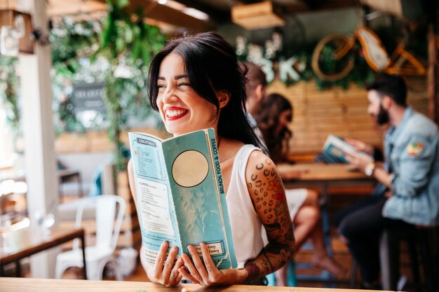 Woman with menu laughing