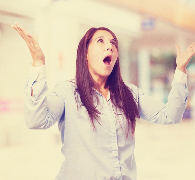 Free photo woman with mouth open and hands raised