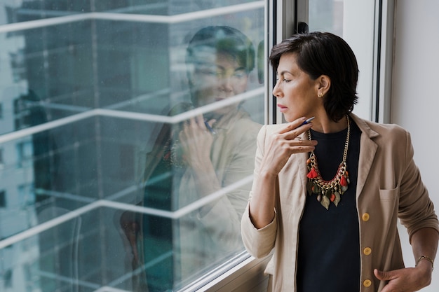 Free photo woman with necklace looking away medium shot