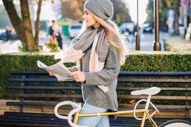 Woman with newspaper and looking away