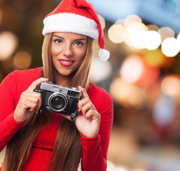 Woman with an old camera in the street