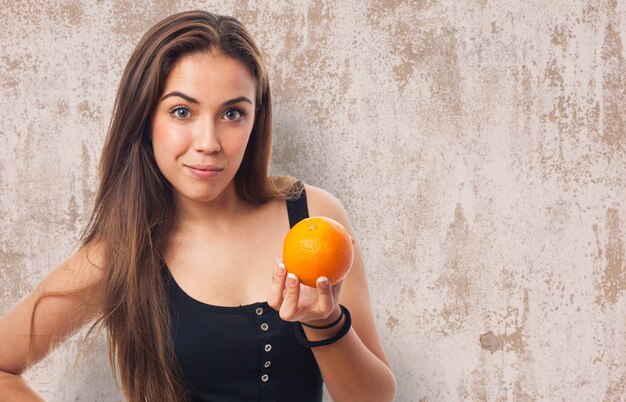 Woman with an orange in her hand