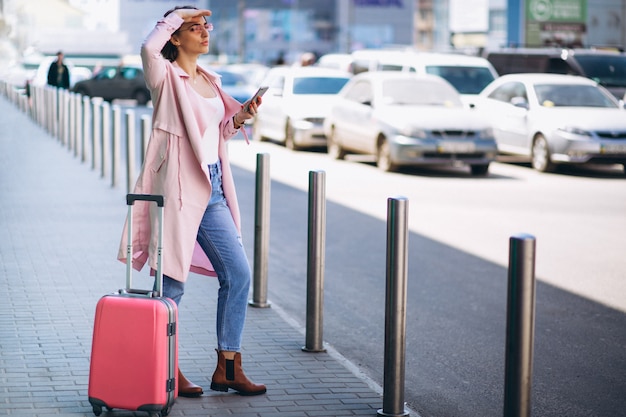 Free photo woman with phone at airport