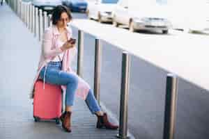 Free photo woman with phone at airport