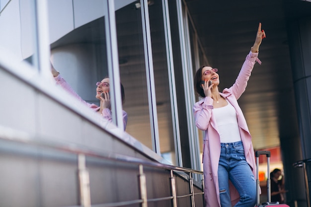 Free photo woman with phone at airport