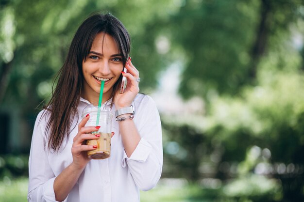 Woman with phone and coffee