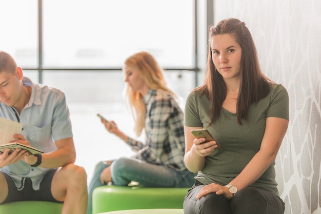 Woman with phone in college