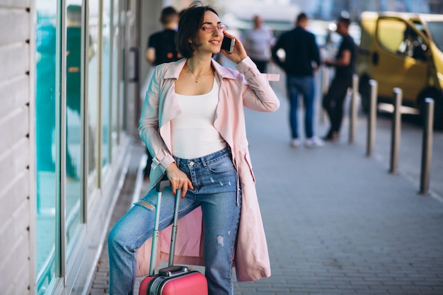 Free Photo woman with phone travelling