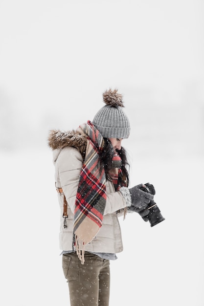 Free photo woman with photo camera in winter